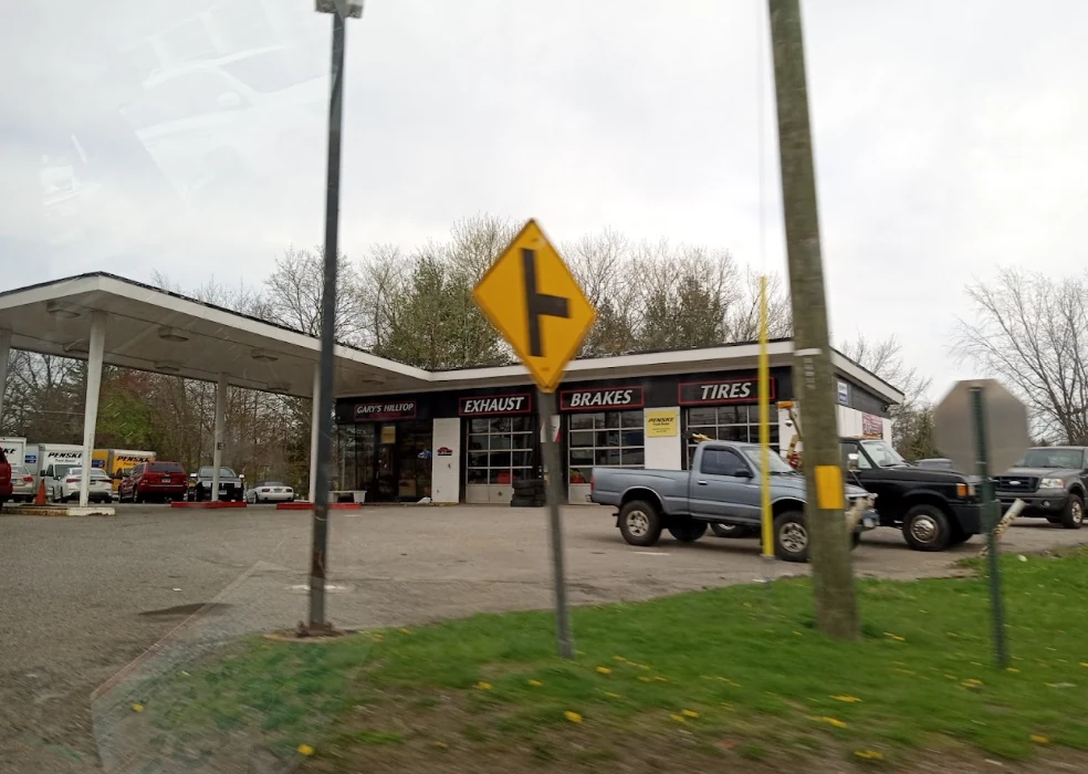 Gary's Hilltop Auto Repair on East Main Street, with exhaust, brakes and tires signs above its service bays